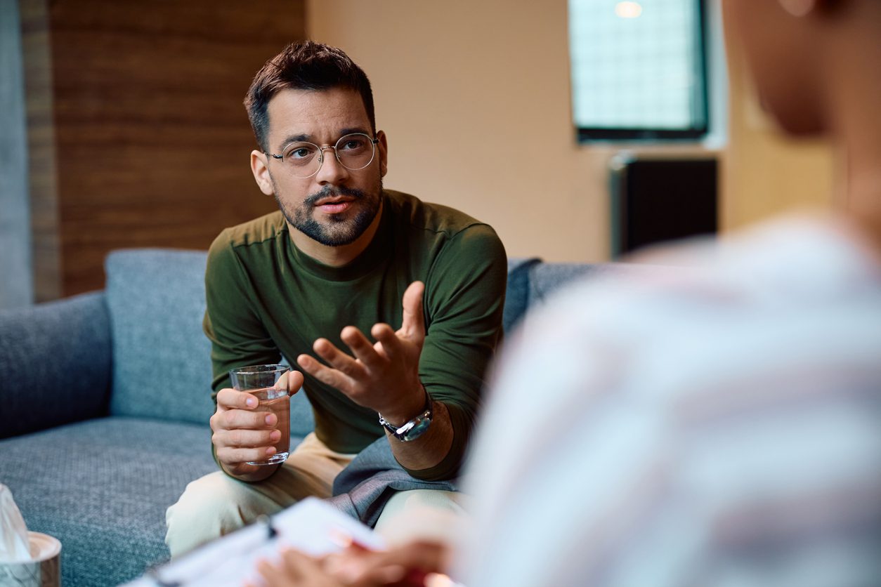 A man talks to a counselor in an office